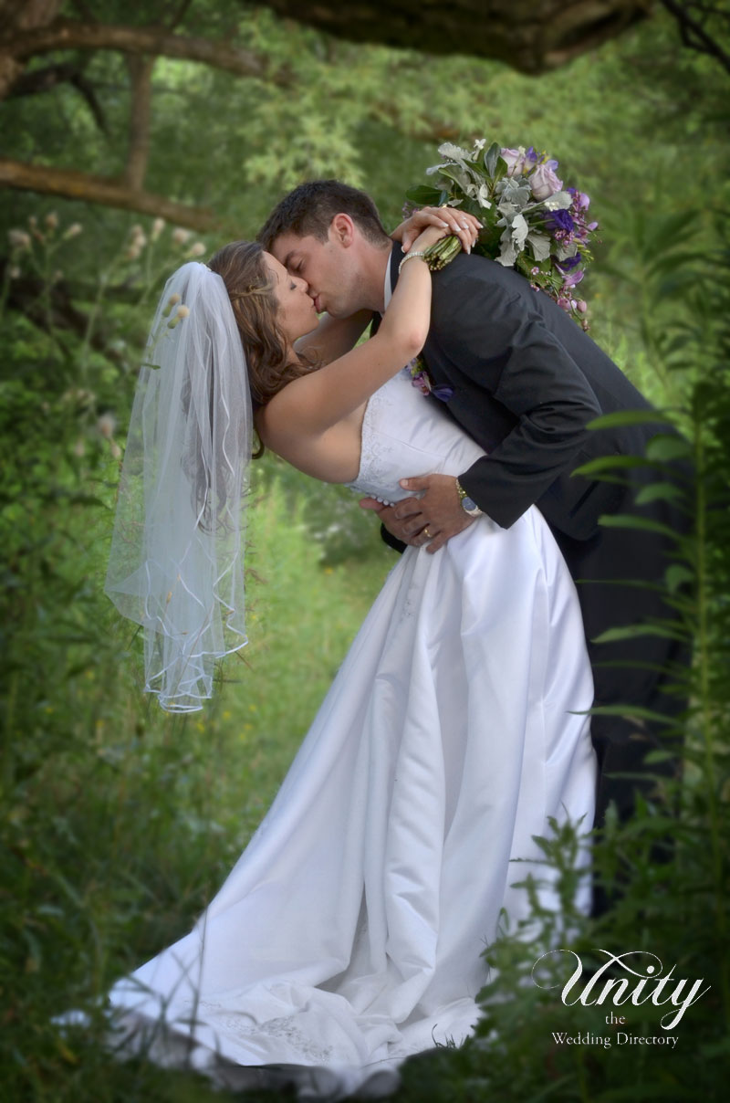 Bride and Groom Kissing in the forest