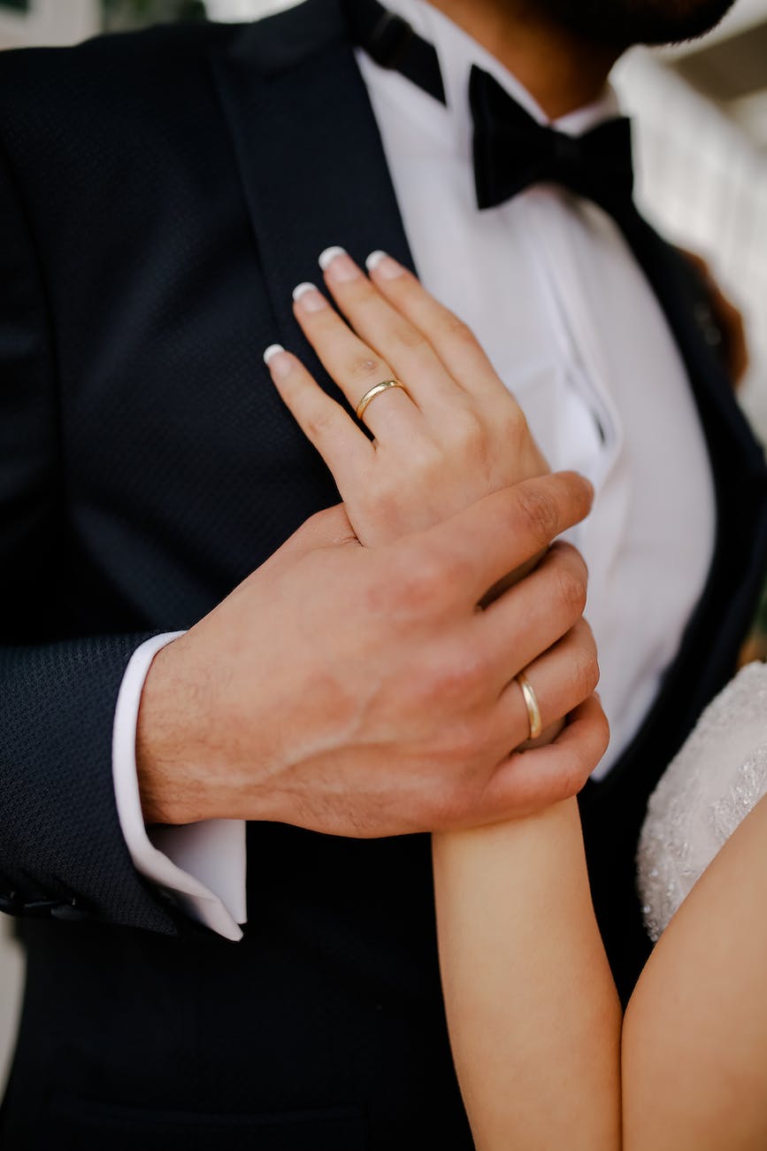husband hand holding wife hand at wedding