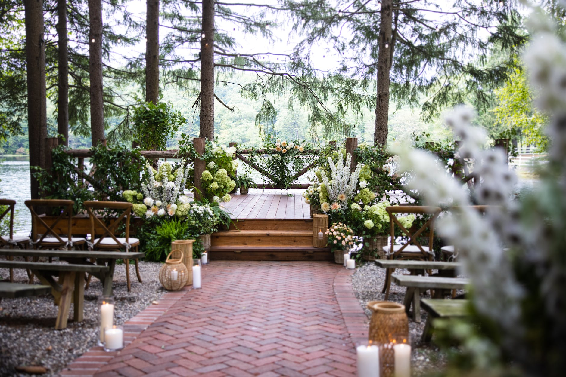 rustic style wedding venue between trees by the lake