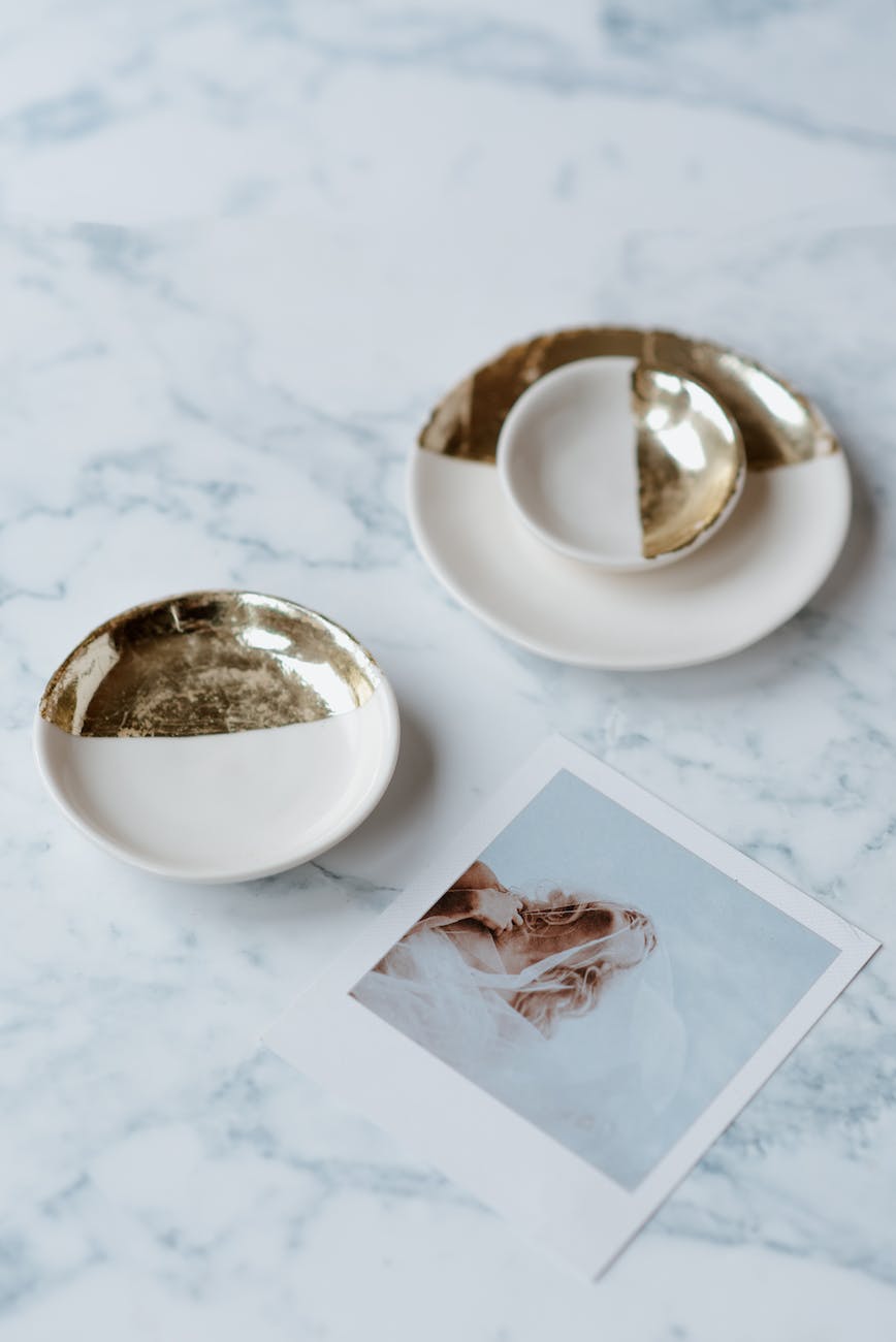 decorative saucers near photography of bride on table