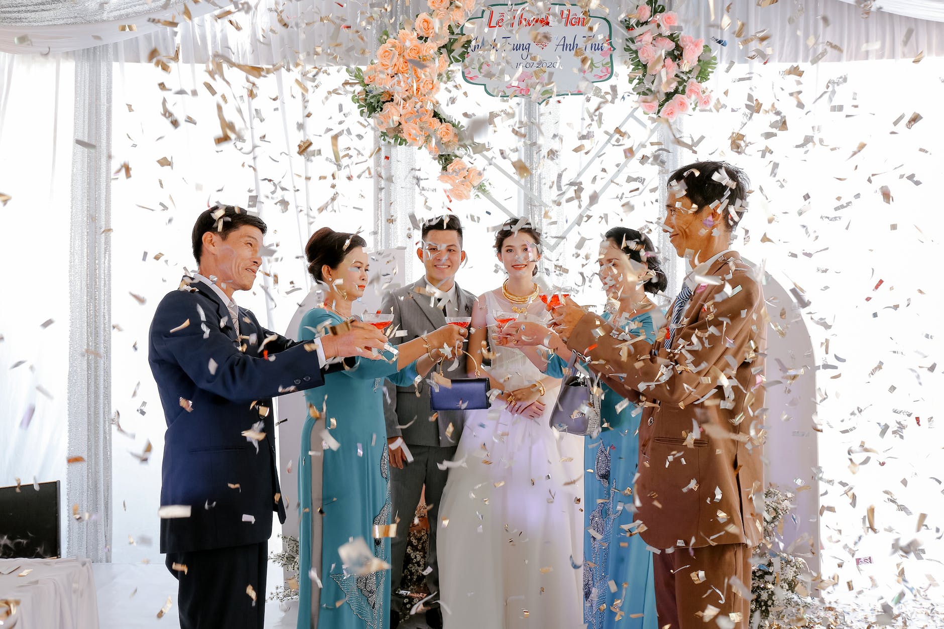 happy newlyweds with guests on wedding celebration