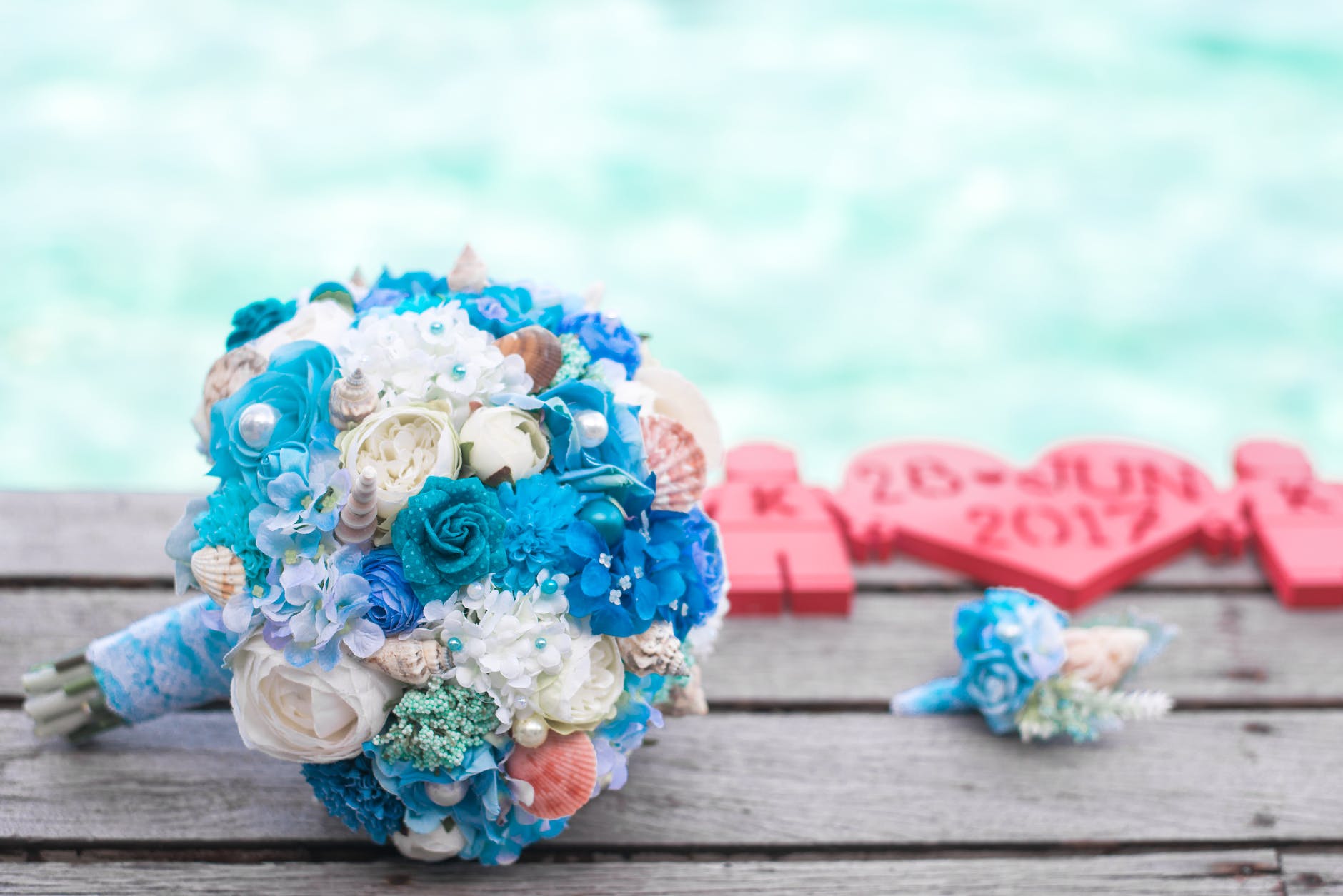 bouquet of blue and white flowers on top of brown surface