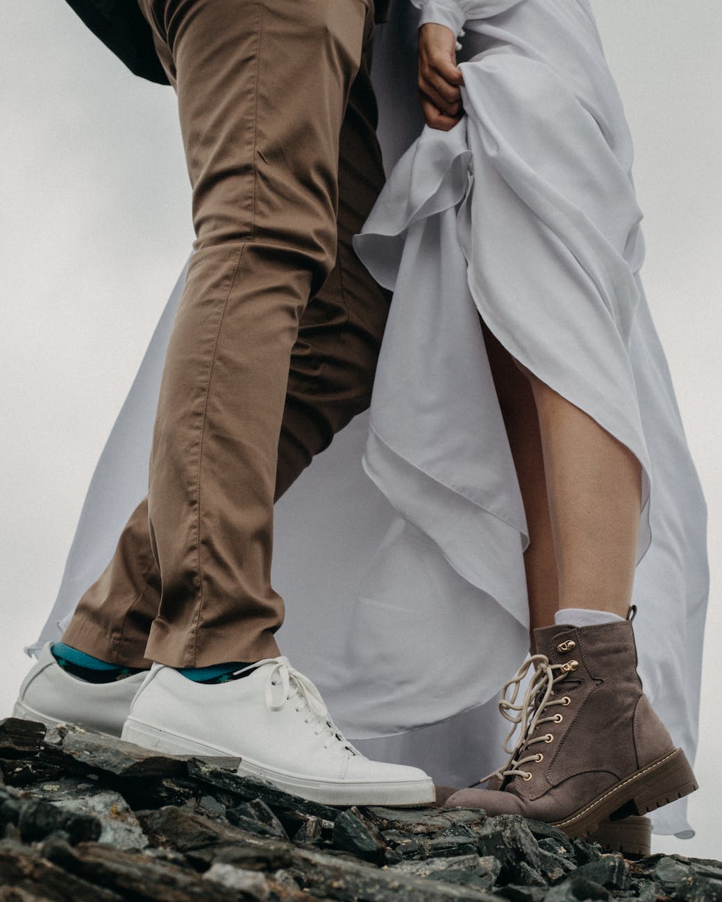 couple in stylish clothes standing on rocky ground