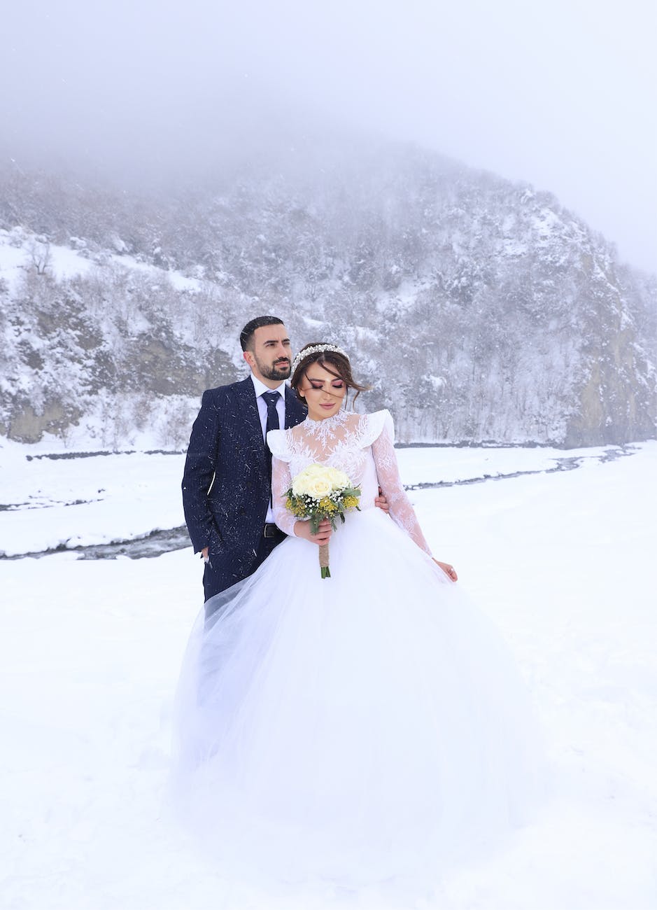 a bride and the groom on a snow covered field